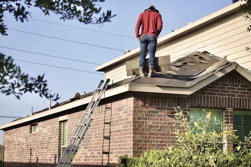 Professional roofer working on a residential roof in Diana Shores